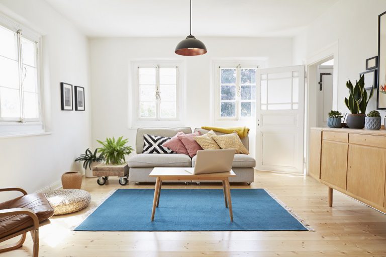 Laptop on coffee table in a modern living room of an old country house